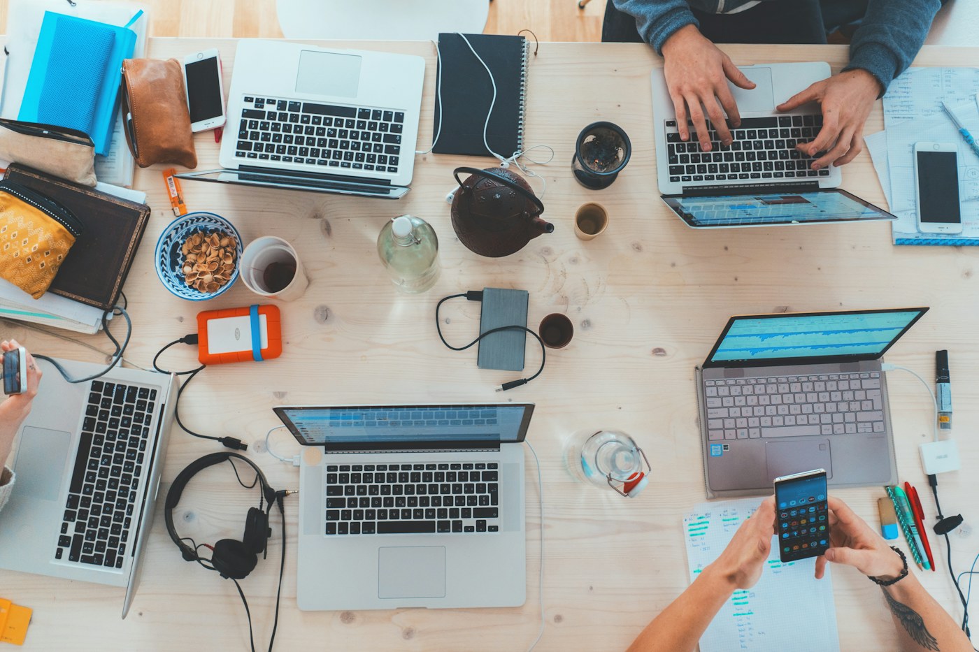 Laptops, camera equipment and portable devices on a shared work table
