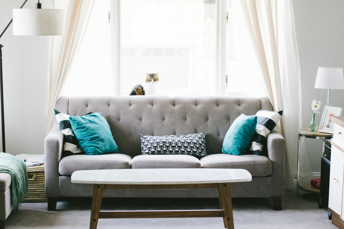 A living room with large windows and bright daylight